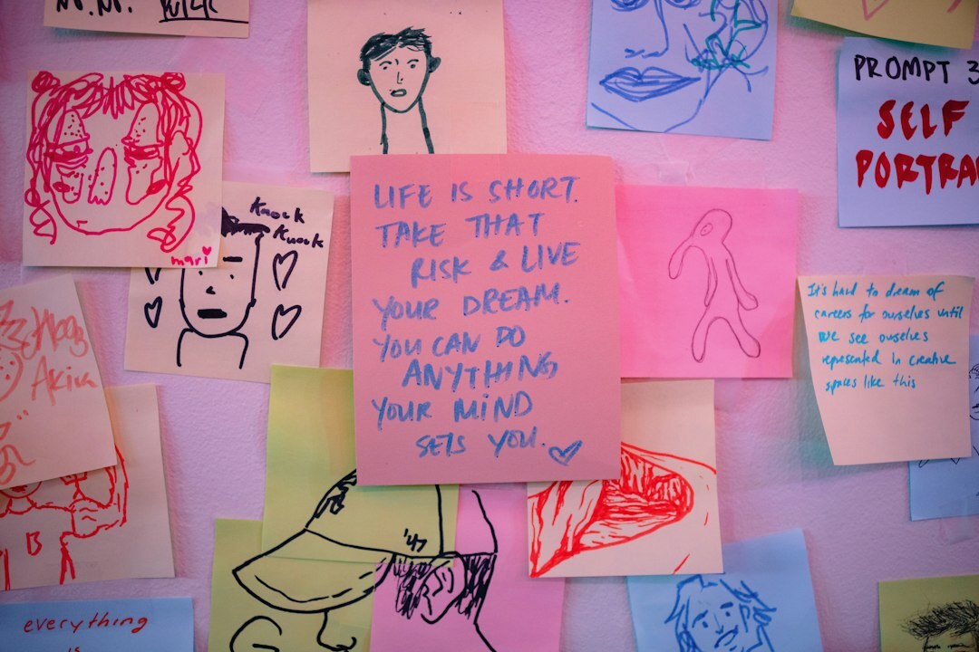 Whiteboard covered with colorful sticky notes and idea sketches