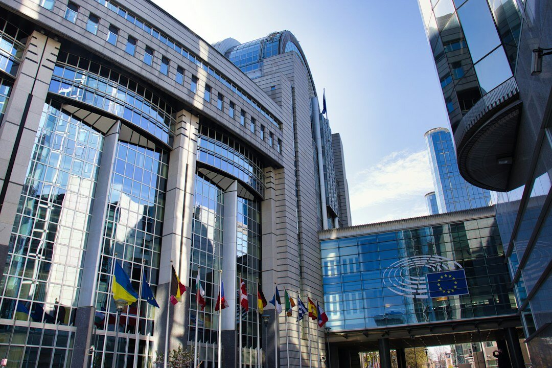 Modern office building entrance with glass facade in a Belgian city